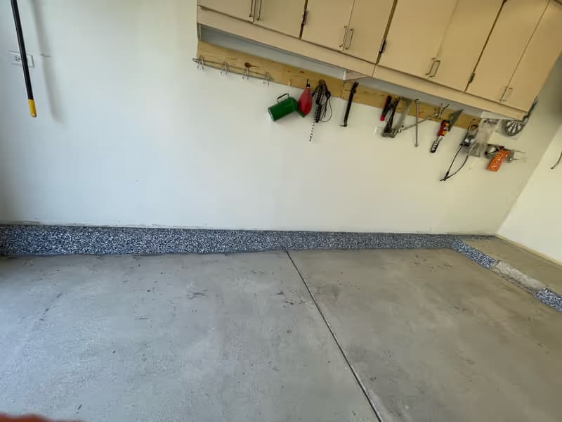Wide view of a residential flake garage floor — even coating to all four walls