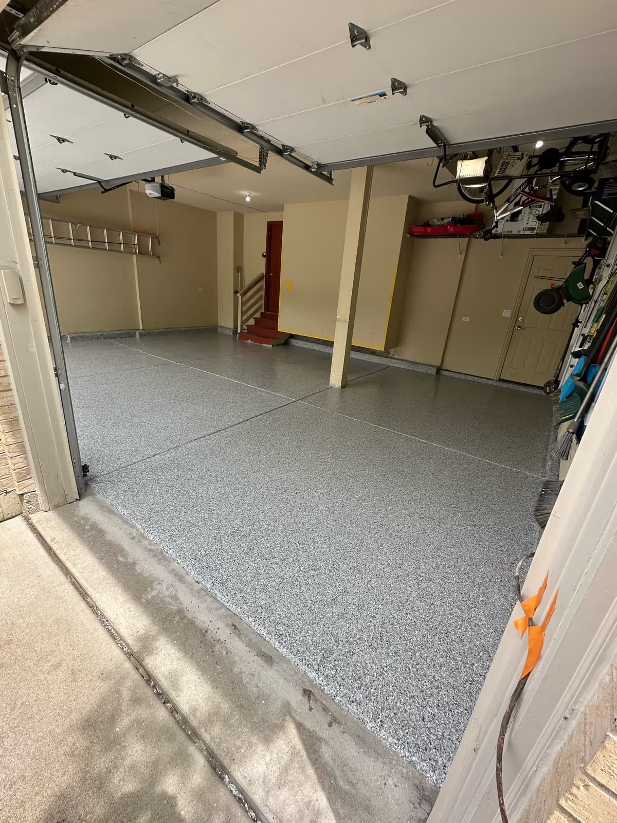 Finished gray flake epoxy garage floor — durable, chip-broadcast coating