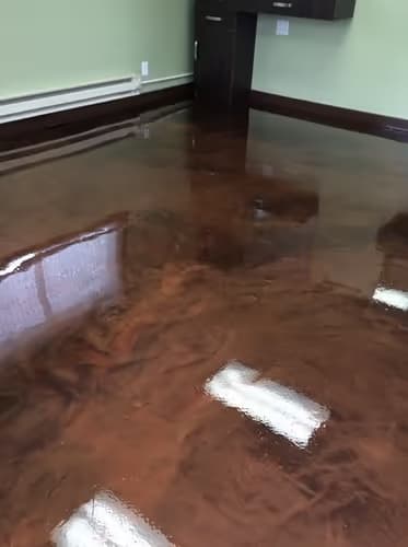 Metallic epoxy floor in a commercial space — showroom-grade gloss finish