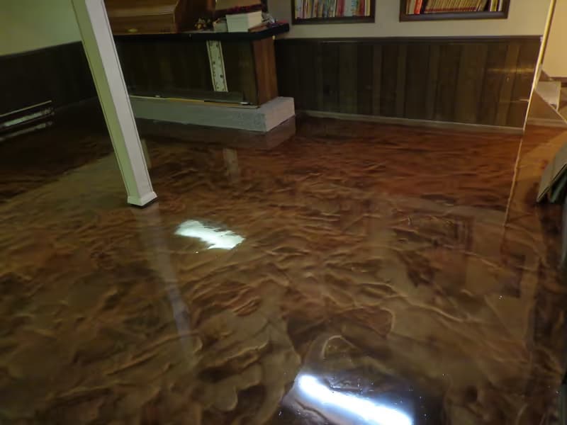 Copper and bronze metallic epoxy basement floor with deep gloss — residential recreation room