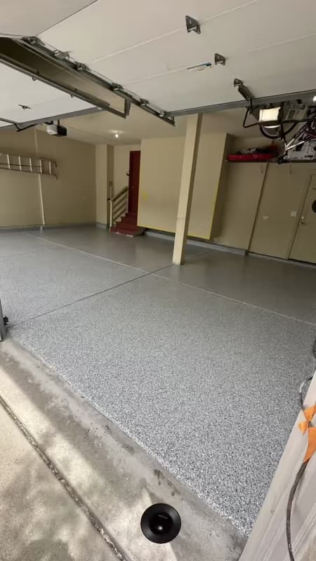 The same garage after Absolute installed a full-broadcast gray flake epoxy floor — job #11655