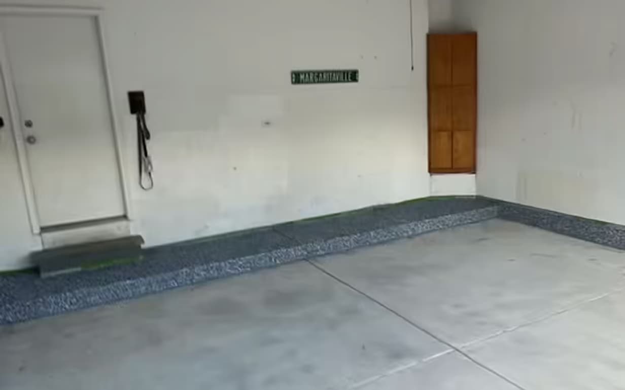 Bare concrete two-car garage floor before Absolute installed the coating
