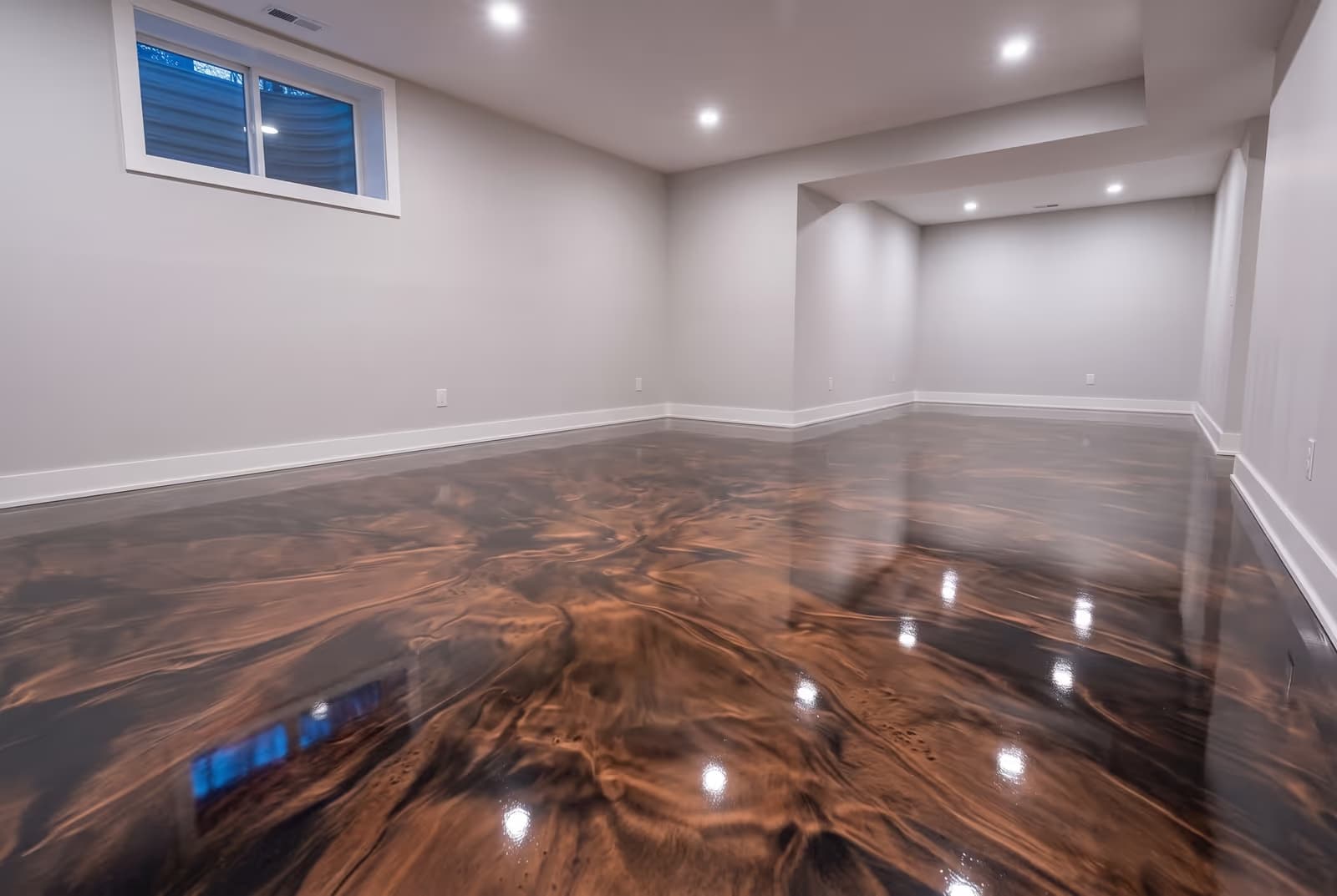Copper and black metallic epoxy across an open basement floor