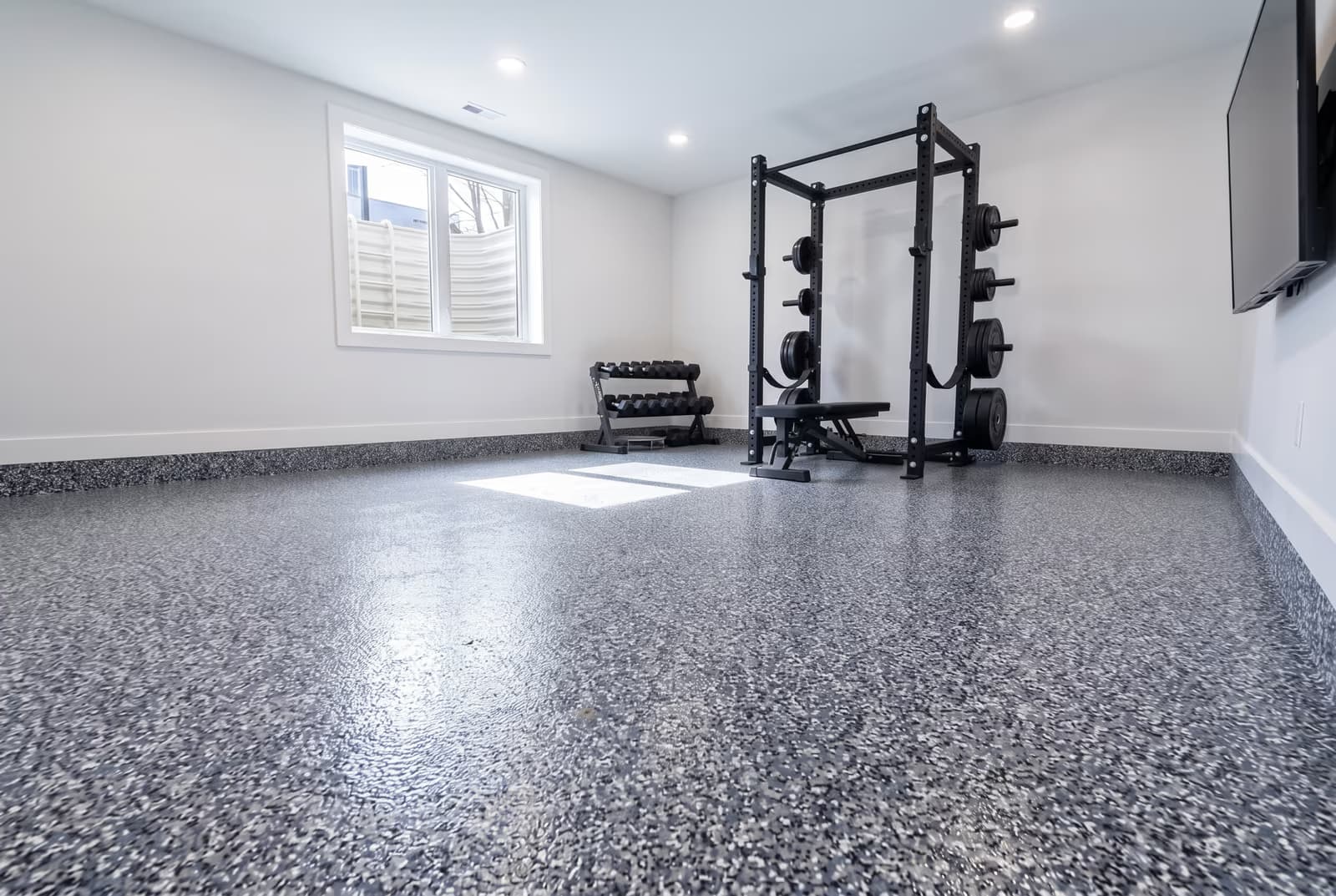 Slate-blue flake epoxy floor in a basement home gym