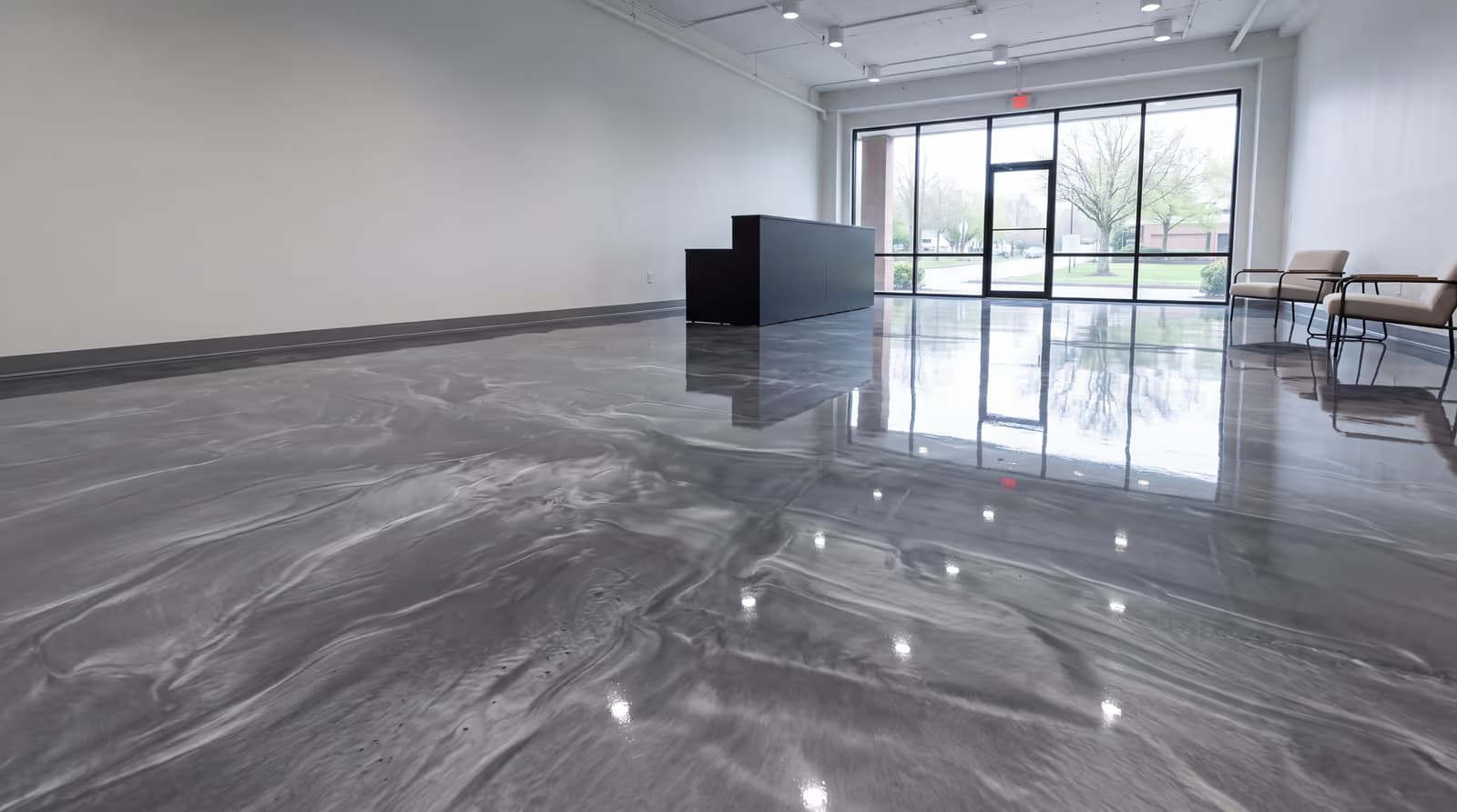 Steel-gray and pearl metallic epoxy floor in a showroom lobby