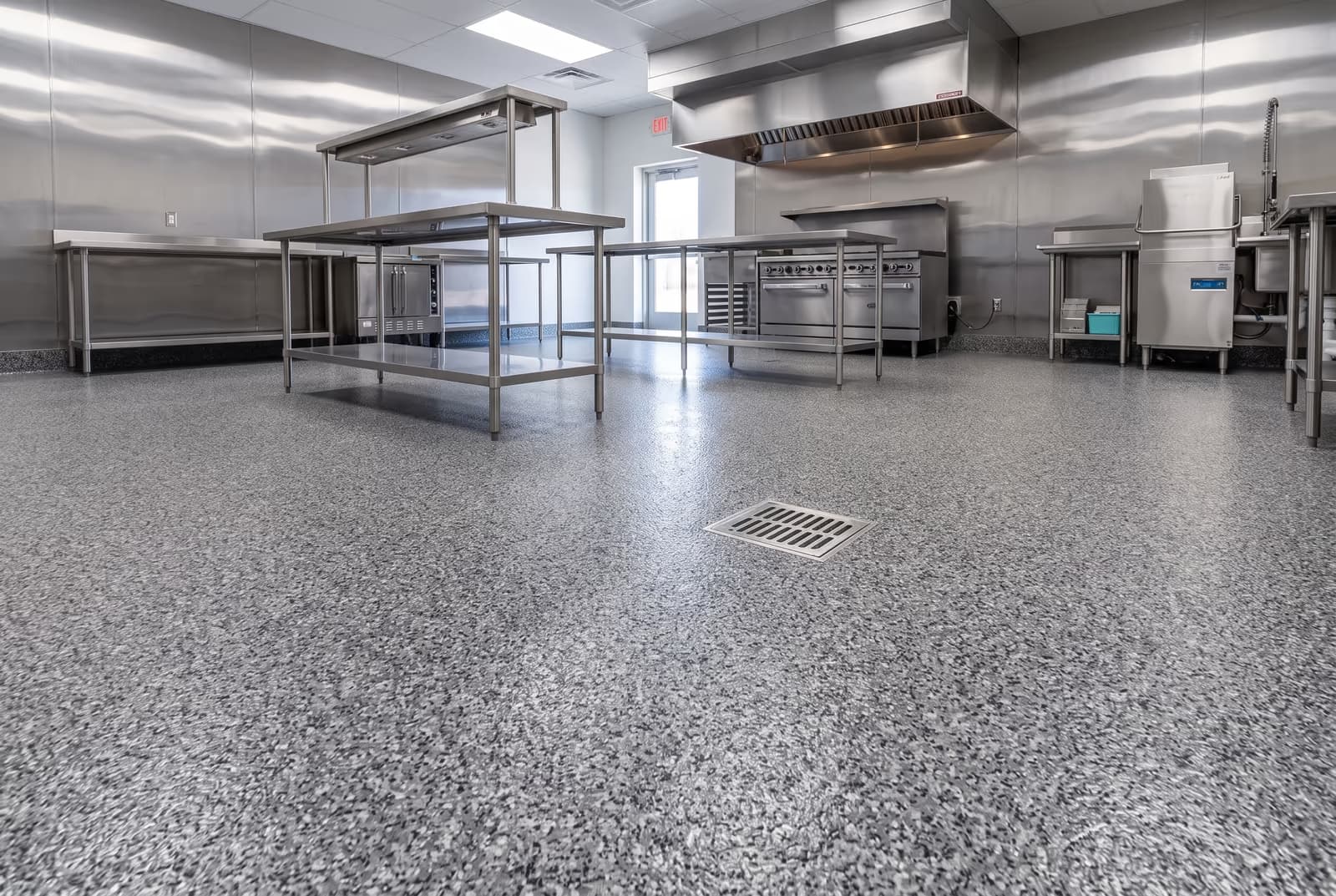 Quarry-gray flake epoxy floor with integral cove in a restaurant kitchen
