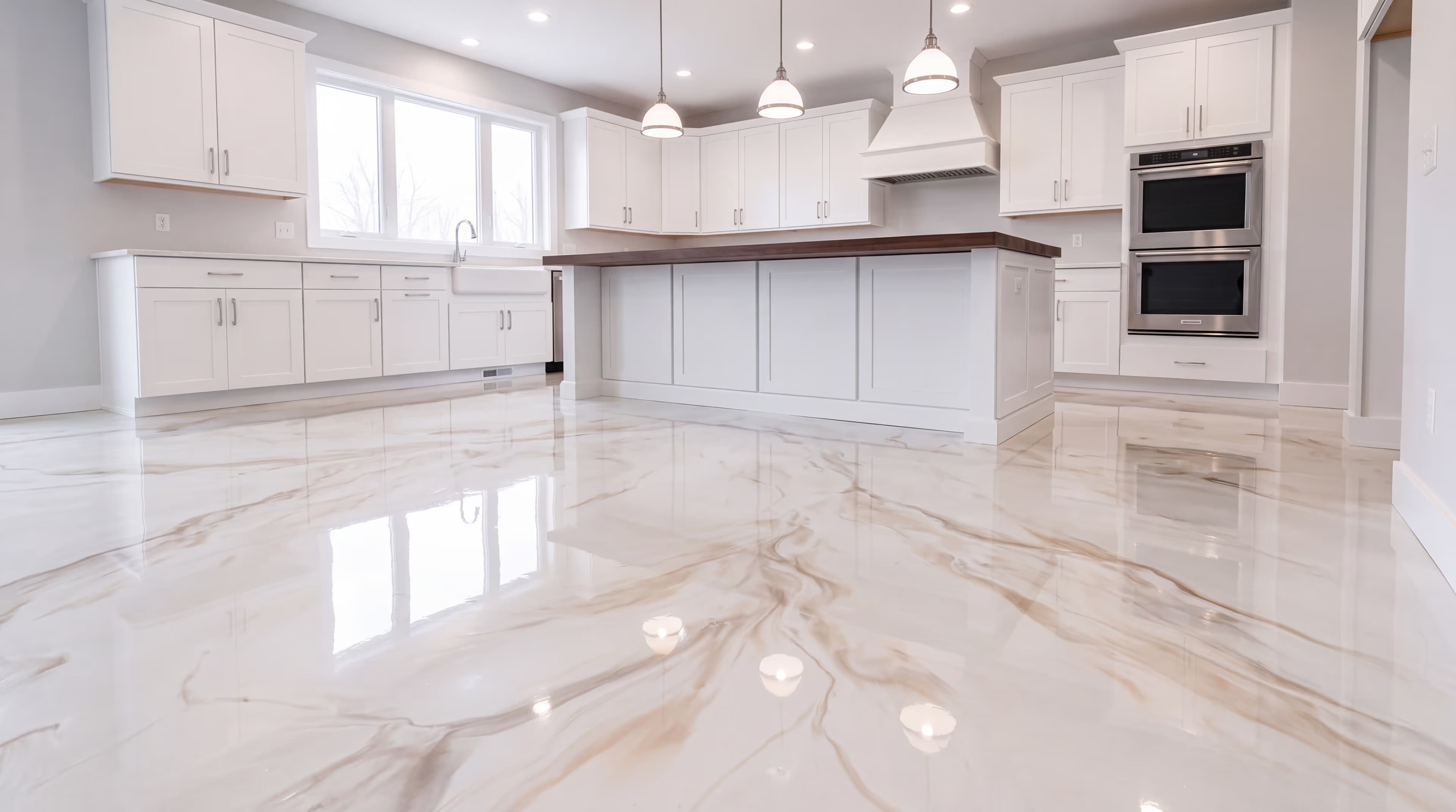 Warm-white metallic epoxy floor with tan and brown marbling in a white shaker kitchen